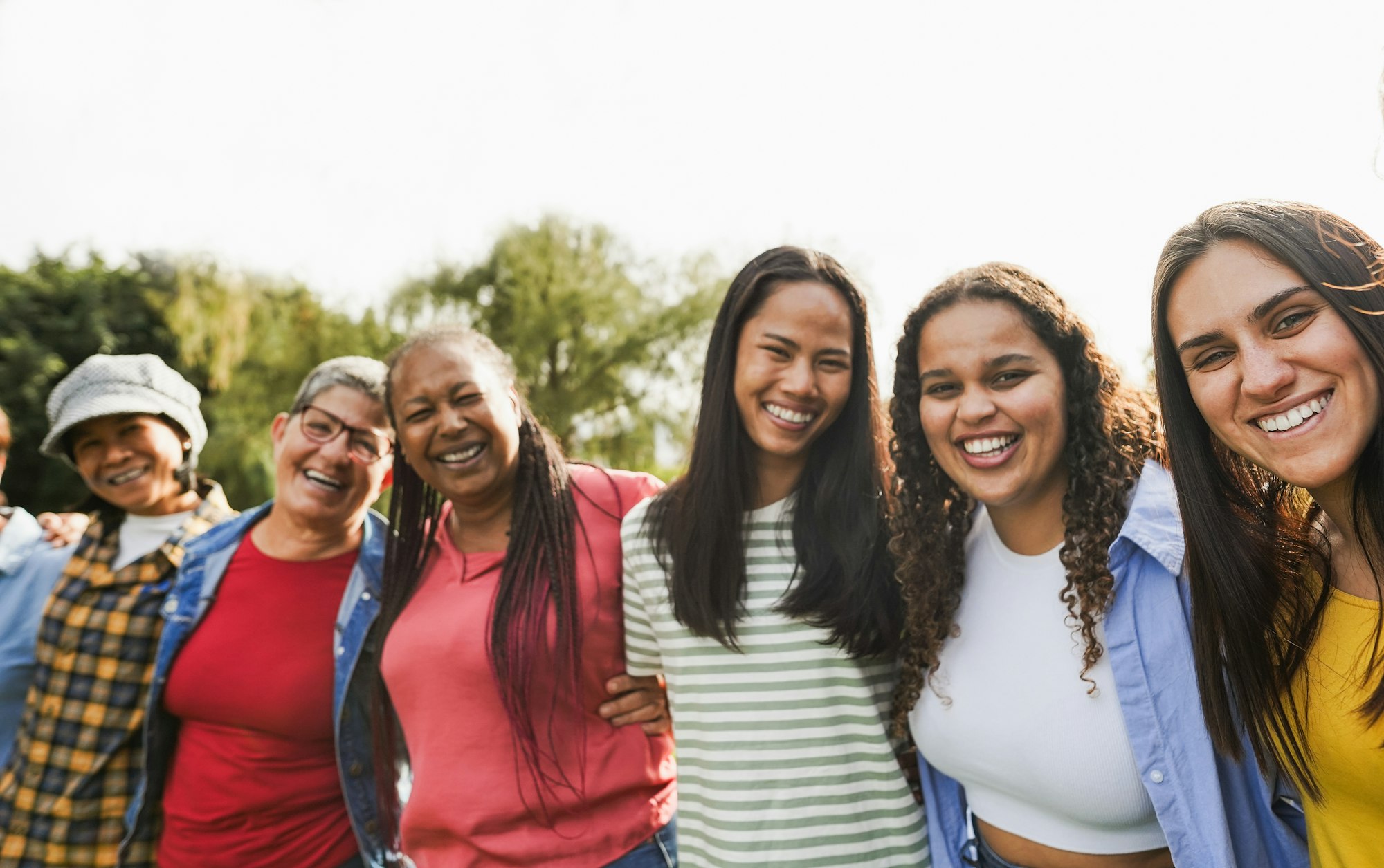 Multi generational women smiling in front of camera