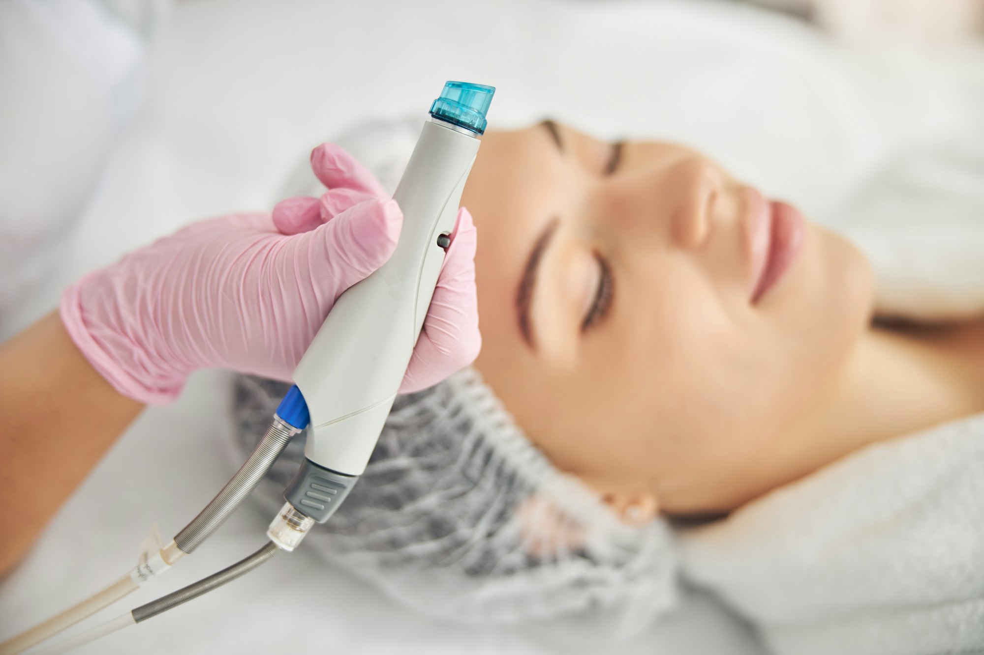 Serene young lady undergoing a skin treatment