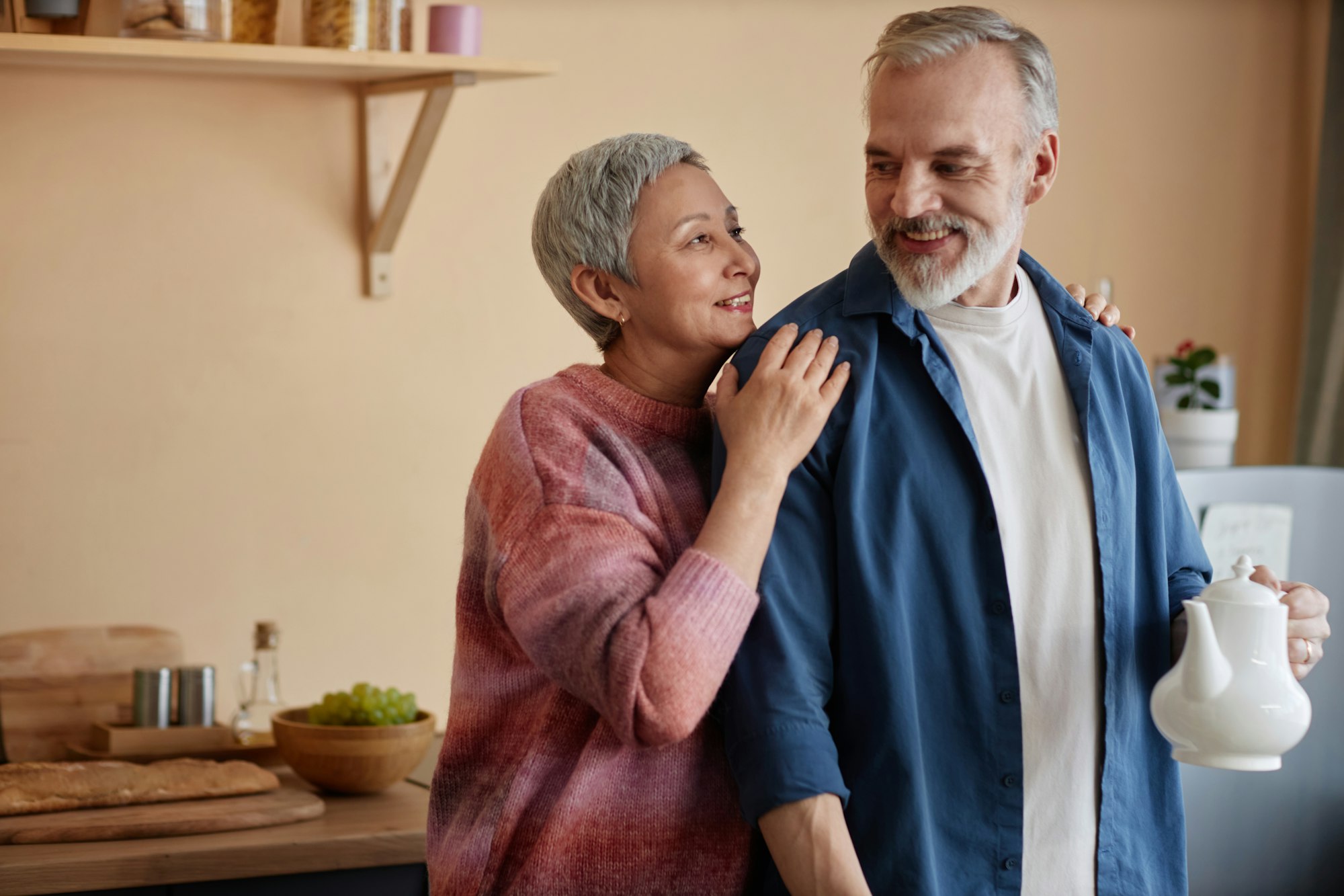 Smiling Senior Couple Embracing at Home